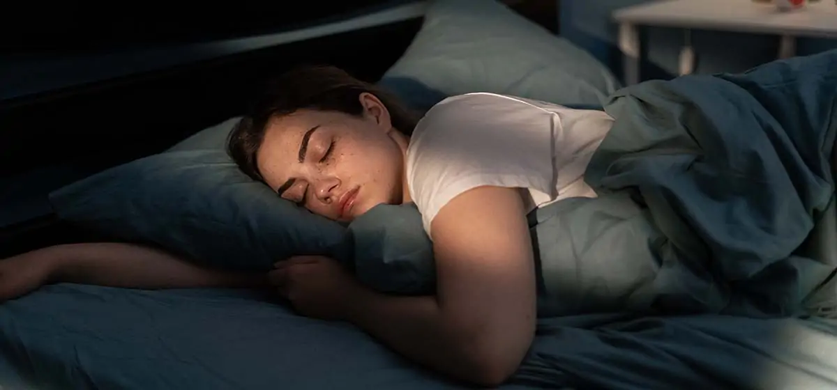 Woman sleeping peacefully for better health and wellness