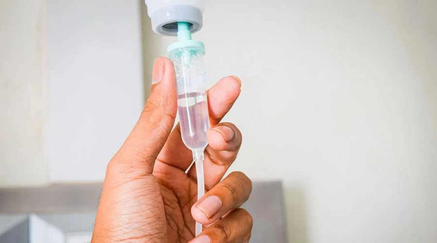 Patient receiving IV infusion during discussion about supportive oligonucleotide therapy for Lyme disease